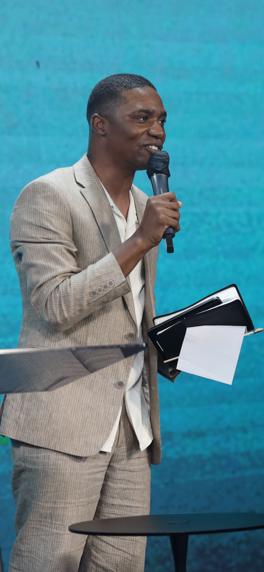 Pastor Stan, founder of The Bible Club, preaching with a Bible in hand